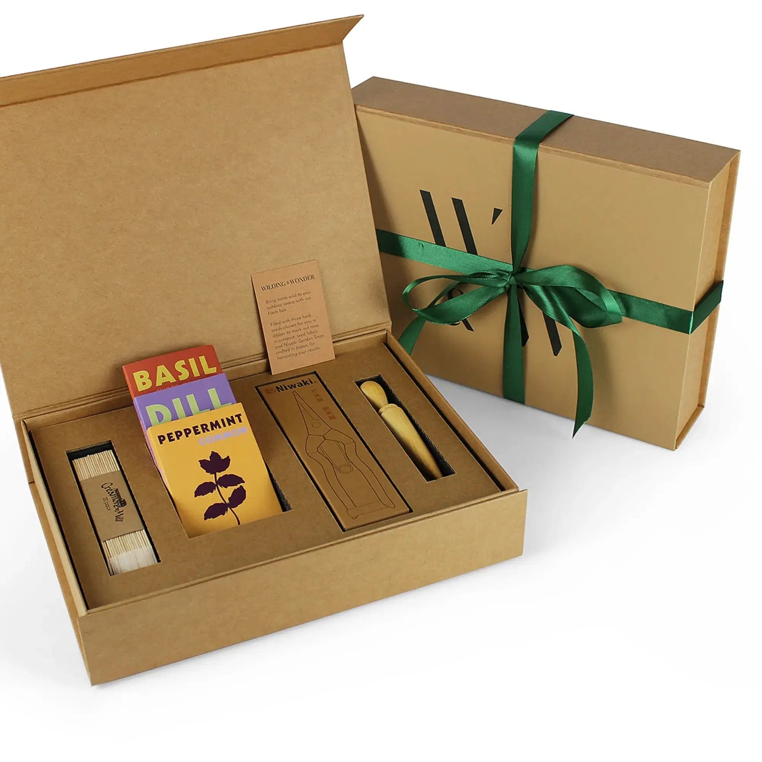 A Limited Edition: Grow Your Own Herbs Kit by Wilding and Wonder, showing the outer brown cardboard gift box with green ribbon and the inside contents.