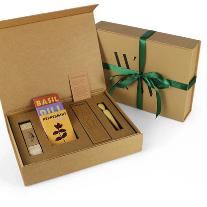A Limited Edition: Grow Your Own Herbs Kit by Wilding and Wonder, showing the outer brown cardboard gift box with green ribbon and the inside contents.