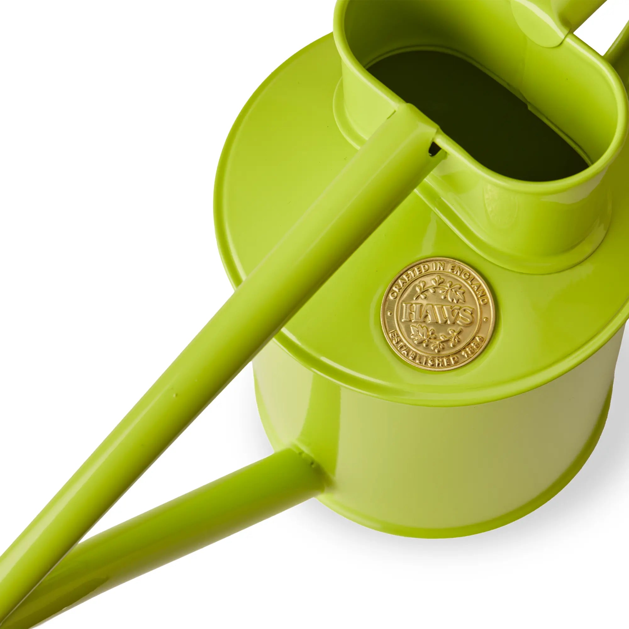A close up view of the top of a Haws Fazeley Flow metal watering can in apple green, showing the detail of the Haws logo imprinted on the can.