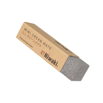 A Niwaki Mini Crean Mate, which is a eraser of rust and sap from tools, packaged in brown cardboard with Japanese characters and the brand name Niwaki visible.