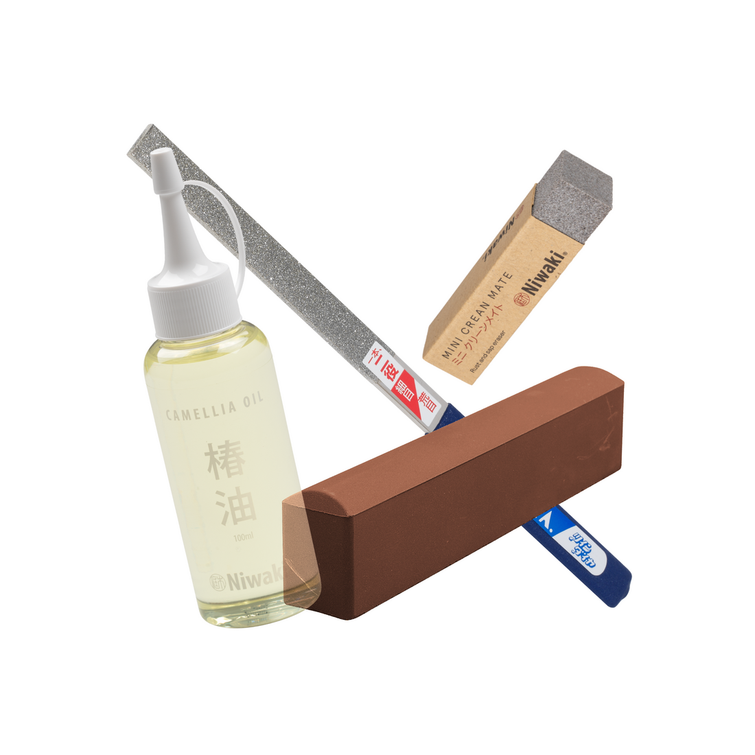 Set of Niwaki sharpening equipment for tools including camellia oil, sharpening stone, twin diamond file and mini Crean mate on a white background.